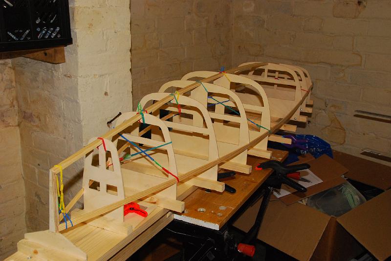 DSC_0001.JPG - Nearly all the frames in place with the gunwale and backbone held in place with elastic bands.